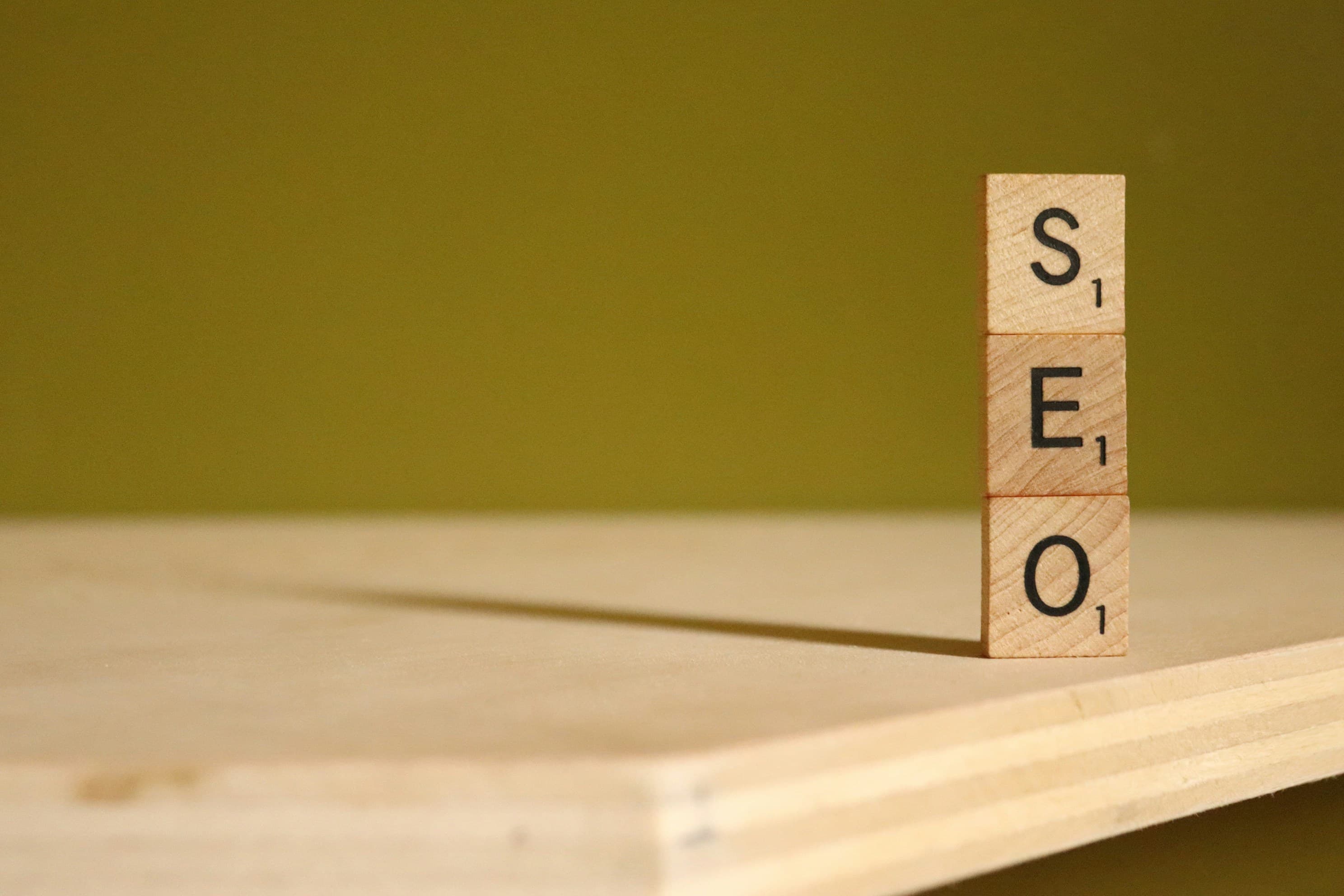 Three blocks of wood stacked vertically forming SEO word